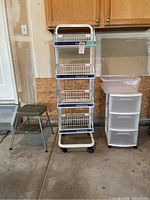 Metal wire rolling storage rack, plastic drawer unit, and two-step stool shown in garage setting