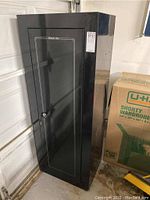 Exterior front view of black Stack-On gun safe