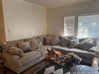 Full view of L-shaped sectional sofa with pillows in living room