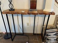 Front view of console table showing live edge wood top and metal legs