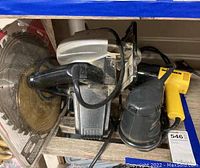 Photo showing multiple power tools including circular saw with blade, orbital sander, and Wagner heat tool.