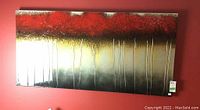 Front view of the lacquered wall art in red, gold, black, and silver tones with vertical textured lines.