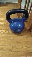 Front side image of blue Element Fitness kettlebell with black handle, showing overall condition and shape.