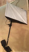 Softbox light on pole with white fabric diffuser visible