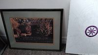 Framed scenic rural photograph with trees and fence, behind glass with mats and black frame
