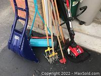 Overview of the yard tools showing snow shovel, garden rakes, tillers, seeder, and gas trimmer.