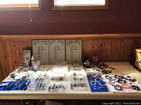 Wide view of organized beads, jewelry pieces, and molds on table