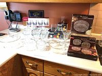 Full view of all crystal and glassware items including boxes on counter