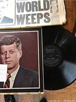 Vinyl record and sleeve depicting John F. Kennedy with a note describing the lot contents.