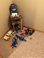 Photo showing the full lot arranged on the floor including figures, ghosts, vehicle and accessories