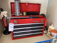 Red Craftsman metal tool chest with five drawers, labeled lot 244, with visible tools on top and around it