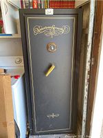 Exterior view of safe showing black finish, gold trim, American Security logo, combination dial and handle