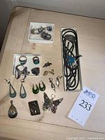 Top view of entire lot on table showing bolo ties, rings, earrings, brooches and pendants