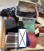 Wooden belt hanger, assorted scarves, wool gloves, handkerchief, knitted scarves, and bandanas; blue hand knit scarf excluded and marked with an X