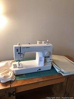 Brother Nouvelle 1500S sewing machine on green cutting mat with cloth scrap