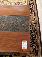 Close-up of table top corner showing wood grain and single tile inlay