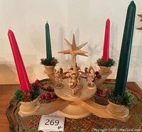 Overall view of wooden Christmas centerpiece with four candles and tray