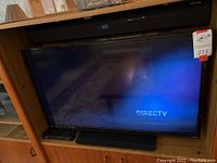 Photo showing Vizio TV powered on with DirecTV display on screen.