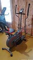 Full side view of Body Power Trio Trainer BRT5088 elliptical and recumbent bike exerciser showing seat, handlebars, and frame.