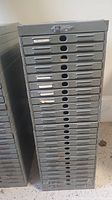 Front view of the complete Victor steel lateral filing cabinet showing all 24 drawers with filing slots and circular finger pull holes.