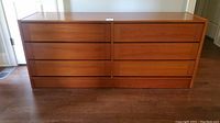 Full front view of the Mid Century Modern teak dresser showing all six drawers closed.