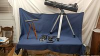 Wide view showing both telescopes, tripods and all accessories on display table