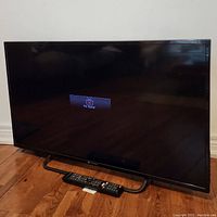 Front view of 40" LED screen resting on stand, display shows "No Signal" message