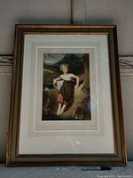 Full view of framed art print showing young woman barefoot with natural landscape background.