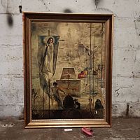 Vintage framed art print with Virgin Mary banner and surreal imagery on a concrete floor near a wall.