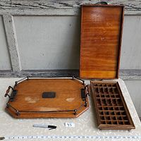 First image shows the three items together: two wooden trays (one with metal railing and wooden handles, one rectangular with hinged lid) and a wooden shelf with compartments.