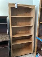 Full front view of the laminate bookcase showing the overall structure and shelves.