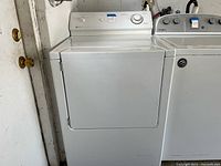 Front view of white Maytag electric dryer showing door closed and control panel.