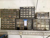 Six plastic parts bins stacked on a wire shelf, containing various small parts and labeled drawers.