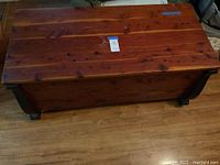 Front and top view of vintage cedar chest showing wood grain and natural finish with some signs of wear