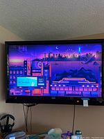 Front view of TV powered on showing screen graphics and bezel