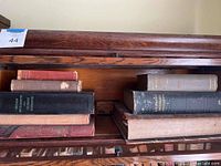 Third image showing a close up of books with varied condition highlighting worn edges and faded text