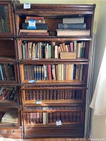 Front view of four-section oak barrister bookcase loaded with books