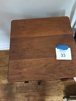 Top view of the wooden side table showing square top surface with minor wear.