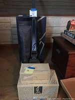 Full view of upright vacuum with two Kirby accessory boxes in front