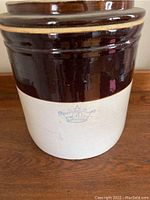 Front view of the large stoneware crock showing the crown and number 4 mark on the glazed section.