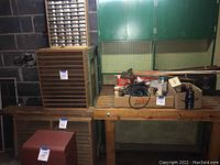 Overview of tool workbench, wooden units, and metal tool boxes in basement setting