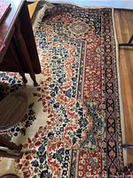 Full view of rug showing pattern, color palette and fringe detail