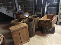Photo showing large wooden barrel, two smaller barrels, a plain wooden fruit box, and a wooden crate labeled J.F. Stansfield.