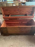 Open vintage Lane cedar chest showing cedar interior with divided tray and green felt lining in compartments under the lid, chest bottom is plain cedar wood.
