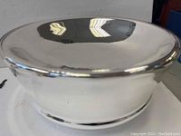 Close-up photo of silver server bowl showing reflective polished surface with no wear.