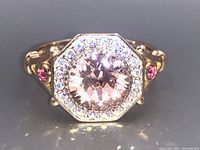 Close-up photo of the octagonal sterling silver ring with a large pink gemstone and clear stones surrounding it. Pink accent stones on the sides of the band visible.