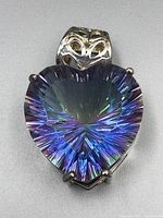 Front view of heart-shaped rainbow quartz pendant showing vibrant multi-colored reflections and decorative silver bail.