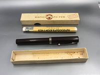 Waterman pen placed alongside Koh-I-Noor Rapidograph pen box and instruction paper