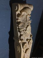Detailed close-up of floral and scroll carved wooden panel