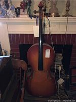 Photo of cello body showing reddish-brown finish and overall condition